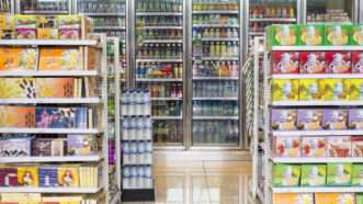 Shelves and cooler in a convenience store. | Tonny Anwar | Dreamstime.com